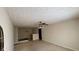 Open living area with neutral carpet, white walls, and partial kitchen view at 5204 Waldrop, Decatur, GA 30034