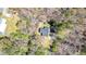 Aerial view of a well-maintained home with dark roof nestled among mature trees at 528 Lower Scott Mill Rd, Canton, GA 30114