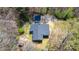 Aerial view of a property with a gray roof, outbuilding, and lush green surroundings at 528 Lower Scott Mill Rd, Canton, GA 30114