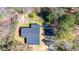 Aerial view of the home and property showing the roof, trees, outbuildings, and driveway at 528 Lower Scott Mill Rd, Canton, GA 30114