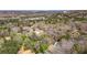 Expansive aerial view showcases a property in a lush, wooded setting with city views in the distance at 528 Lower Scott Mill Rd, Canton, GA 30114