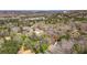 Expansive aerial view showcases a property in a lush, wooded setting with city views in the distance at 528 Lower Scott Mill Rd, Canton, GA 30114