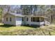 Exterior of the home featuring a screened in porch and backyard at 528 Lower Scott Mill Rd, Canton, GA 30114