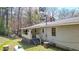 Back exterior of the home with a covered porch, gray siding, and some stairs at 528 Lower Scott Mill Rd, Canton, GA 30114