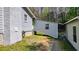A home's backyard area featuring grass, a white brick exterior and some outbuildings at 528 Lower Scott Mill Rd, Canton, GA 30114