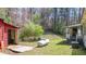 A large propane tank is sitting in the backyard close to other outbuildings at 528 Lower Scott Mill Rd, Canton, GA 30114