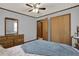 Comfortable bedroom with a ceiling fan, wood trim, and a spacious closet for ample storage at 528 Lower Scott Mill Rd, Canton, GA 30114