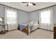 Cozy bedroom featuring soft carpet, a ceiling fan, and natural light from two large windows at 528 Lower Scott Mill Rd, Canton, GA 30114