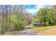 Driveway leading to the property with a view of trees and outbuildings on a sprawling lot at 528 Lower Scott Mill Rd, Canton, GA 30114
