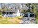 Quaint house with a cozy screened-in porch and detached two-car garage nestled among the trees at 528 Lower Scott Mill Rd, Canton, GA 30114