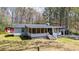 Sweet cottage featuring a screened-in porch and a separate shed, offering a relaxed, country feel at 528 Lower Scott Mill Rd, Canton, GA 30114