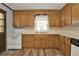 Functional kitchen with wood cabinets and essential appliances, next to a door at 528 Lower Scott Mill Rd, Canton, GA 30114
