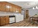 Kitchen with laundry appliances, wood cabinets and eat in dining area at 528 Lower Scott Mill Rd, Canton, GA 30114