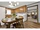 Kitchen with wood cabinets and dining area featuring an adjacent laundry setup at 528 Lower Scott Mill Rd, Canton, GA 30114