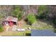 Aerial view of an outbuilding with a red exterior and metal roof on a wooded lot at 528 Lower Scott Mill Rd, Canton, GA 30114