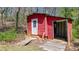 An outbuilding features painted, horizontal siding, and a concrete slab at 528 Lower Scott Mill Rd, Canton, GA 30114
