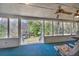 Relaxing screened-in porch complete with seating and ceiling fans offering scenic backyard views at 528 Lower Scott Mill Rd, Canton, GA 30114