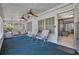 Cozy screened porch featuring comfortable seating and two ceiling fans with easy access to indoor living area at 528 Lower Scott Mill Rd, Canton, GA 30114