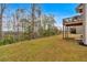 Spacious backyard with a deck, mature trees, and a lush lawn at 822 Pine Way, Dallas, GA 30157