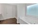 Bathroom featuring a soaking tub, glass door shower, and vinyl flooring at 822 Pine Way, Dallas, GA 30157