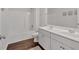 Bright bathroom boasts double sinks, white cabinets, and a tub with shower at 822 Pine Way, Dallas, GA 30157