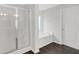Bathroom showcasing glass door shower, soaking tub, and dark vinyl flooring at 822 Pine Way, Dallas, GA 30157