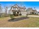 Inviting two-story home with a well-maintained lawn, landscaping, and an attached two-car garage at 822 Pine Way, Dallas, GA 30157