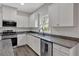 Stylish kitchen boasts granite countertops, stainless steel appliances, and white cabinets with backyard view at 822 Pine Way, Dallas, GA 30157