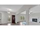 Open-concept living area with a fireplace, access to the deck, and modern lighting at 822 Pine Way, Dallas, GA 30157
