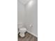 This half bathroom features hardwood floors, white walls, and a white toilet at 822 Pine Way, Dallas, GA 30157