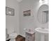 Elegant half bath featuring a pedestal sink, framed artwork, and a decorative oval mirror at 822 Pine Way, Dallas, GA 30157