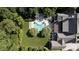 Aerial view of the property highlighting a sparkling pool, lush landscaping, and the overall layout of the backyard at 5495 Mount Vernon Pkwy, Atlanta, GA 30327