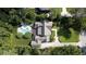 An aerial view of the property showcases the home's architecture, mature trees, and pristine landscaping for serene living at 5495 Mount Vernon Pkwy, Atlanta, GA 30327