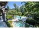 Expansive backyard featuring a spa and pool, nestled within meticulously maintained landscaping and lush greenery at 5495 Mount Vernon Pkwy, Atlanta, GA 30327