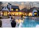 Stunning backyard features a sparkling pool with a waterfall feature at dusk at 5495 Mount Vernon Pkwy, Atlanta, GA 30327