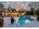 Serene backyard showcasing a sparkling pool with a gentle waterfall feature at 5495 Mount Vernon Pkwy, Atlanta, GA 30327