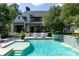 Stunning backyard with a sparkling pool, waterfall feature, and lush landscaping surrounding the property at 5495 Mount Vernon Pkwy, Atlanta, GA 30327