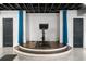 An exercise bike sits on a raised platform between two dark doors in this finished basement at 5495 Mount Vernon Pkwy, Atlanta, GA 30327