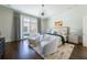 Bright, airy bedroom with hardwood floors, designer lighting, and a comfortable seating area at 5495 Mount Vernon Pkwy, Atlanta, GA 30327