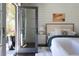 Light-filled primary bedroom with French doors, hardwood floors, and neutral decor for a serene atmosphere at 5495 Mount Vernon Pkwy, Atlanta, GA 30327