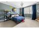 Spacious bedroom featuring a blue bedset, carpet floor, and ample natural light at 5495 Mount Vernon Pkwy, Atlanta, GA 30327