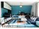 Upstairs bonus room featuring a gaming area with blue accent wall and sofa at 5495 Mount Vernon Pkwy, Atlanta, GA 30327