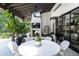 Stylish covered patio featuring outdoor dining, fireplace, TV, hanging chair, and outdoor seating area at 5495 Mount Vernon Pkwy, Atlanta, GA 30327