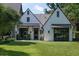 Charming home featuring a well-manicured lawn, dark window frames, and a modern garage door for an inviting curb appeal at 5495 Mount Vernon Pkwy, Atlanta, GA 30327