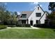 Beautiful home with a manicured front lawn, elegant landscaping, and classic architecture creates a welcoming curb appeal at 5495 Mount Vernon Pkwy, Atlanta, GA 30327