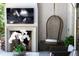 Cozy outdoor fireplace with a mounted TV, hanging chair, and mantle with stylish orchid arrangement at 5495 Mount Vernon Pkwy, Atlanta, GA 30327