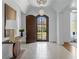 Elegant foyer with stone flooring, arched doorway, designer lighting and console table at 5495 Mount Vernon Pkwy, Atlanta, GA 30327