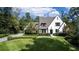 Beautifully landscaped front yard with circular driveway and classic Tudor-style home at 5495 Mount Vernon Pkwy, Atlanta, GA 30327