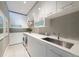 Modern laundry room with sleek white cabinets, ample counter space, and contemporary appliances for efficient chores at 5495 Mount Vernon Pkwy, Atlanta, GA 30327