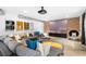 Comfortable living room with an oversized couch, home theater setup, and brick accent wall at 5495 Mount Vernon Pkwy, Atlanta, GA 30327